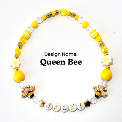 Yellow gold and crystal beads with daisy and bee accents and letter beads with your name. personalized.