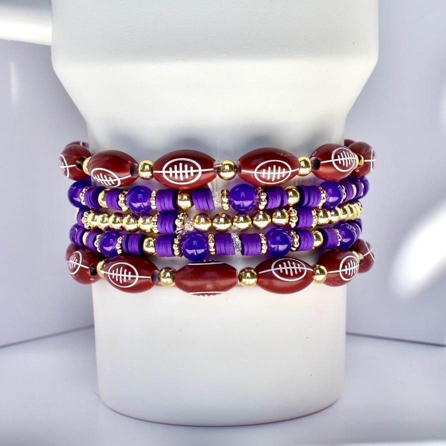 Set of beaded bracelets with football design on a white Stanley tumbler