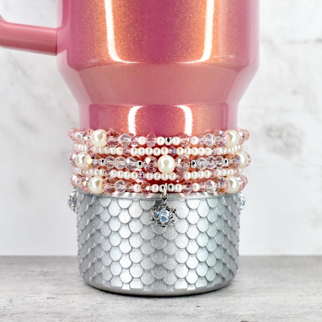 Pink glittery mug with pearl and crystal beaded wrap on a white background