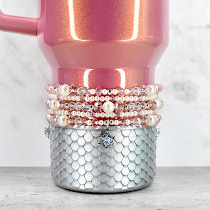 Pink glittery mug with pearl and crystal beaded wrap on a white background