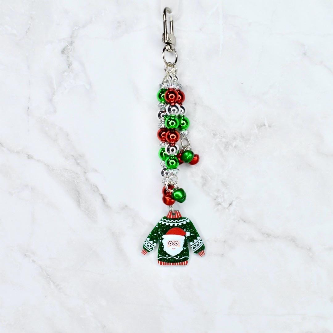 Christmas-themed keychain with Santa Claus ugly sweater design on a white background