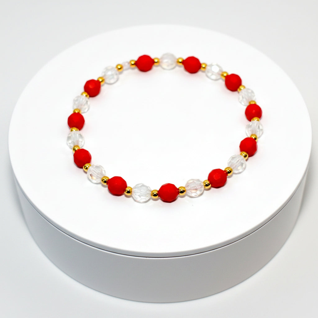 A red and clear crystal bracelet with gold beads. The bracelet is on a white background. The text Design Name: Crystal Berry Bliss is printed below the bracelet.