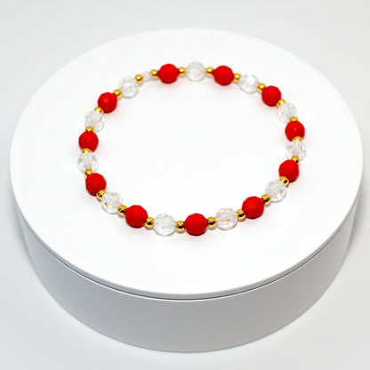 A red and clear crystal bracelet with gold beads. The bracelet is on a white background. The text Design Name: Crystal Berry Bliss is printed below the bracelet.