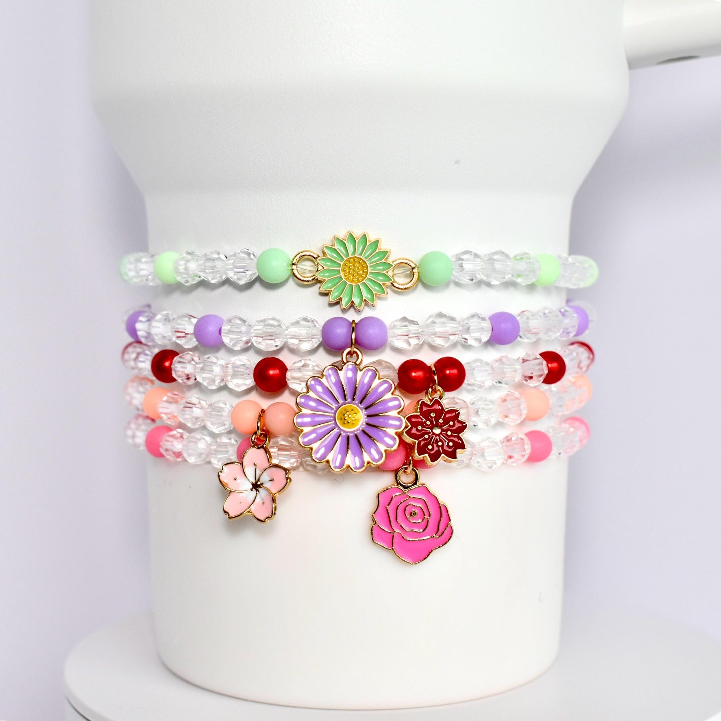 Clear and colored beaded bracelets with flower charm accents.  for wrist tumbler Stanley.  