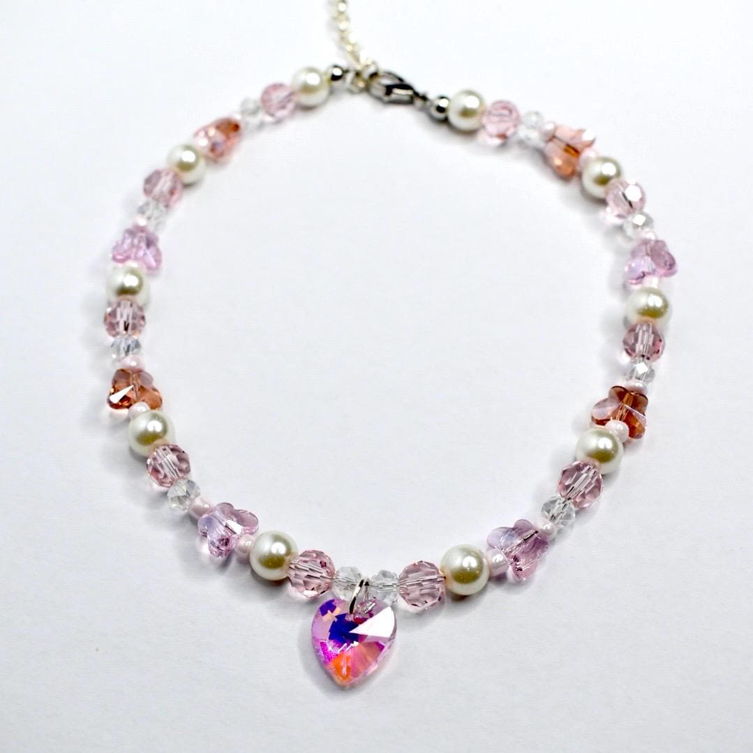 Beaded Necklace with heart-shaped crystal pendant on a white background
