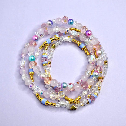 Set of colorful beaded bracelets on a light purple background