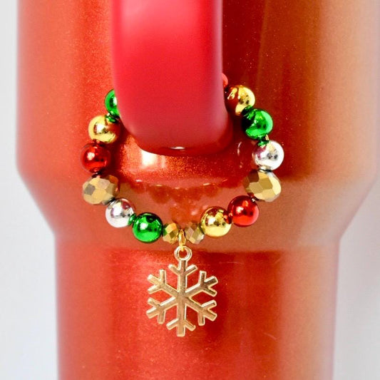 Beaded tumbler handle bracelet with a gold snowflake charm on a red Stanley tumbler
