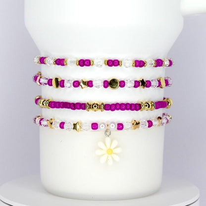 Bracelets for wrist or tumbler (Stanley and others) with magenta gold and clear beads with daisy charm.