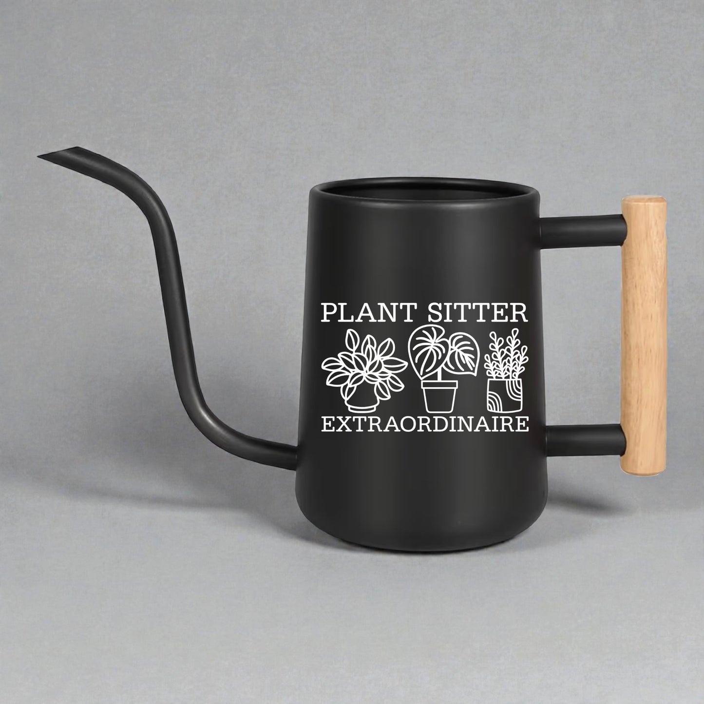 Black watering can with wooden handle and 'Plant Sitter Extraordinaire' text on a gray background