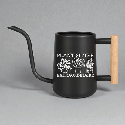 Black watering can with wooden handle and 'Plant Sitter Extraordinaire' text on a gray background