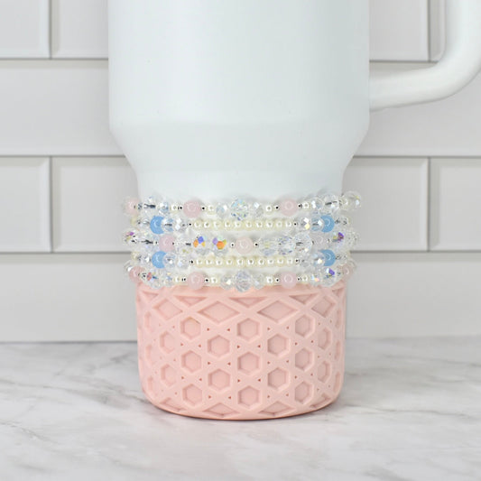 White Stanley tumbler with decorative beads on a white background