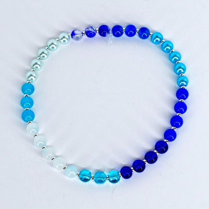 Blue beaded bracelet on a white background