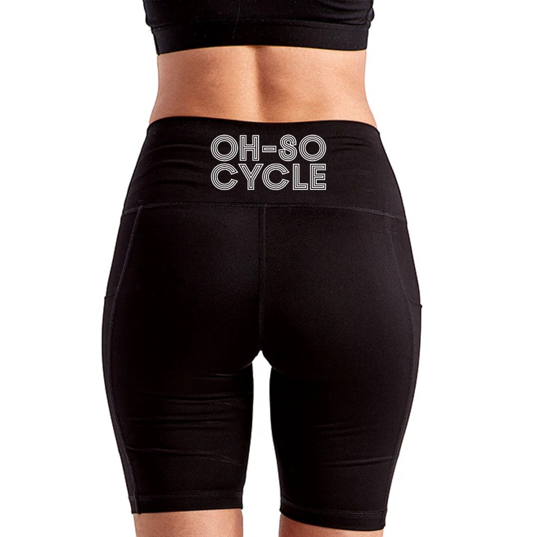 Calathea Collective black high-waisted bike shorts with side pockets and "OH-SO CYCLE" logo on back waistband.
