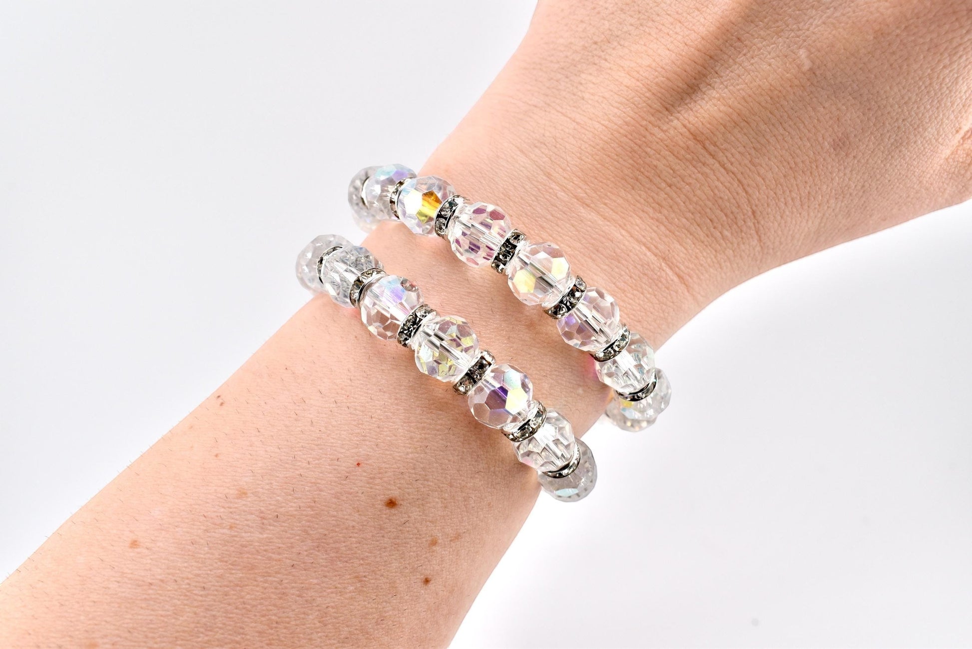 Calathea Collective iridescent crystal wrap bracelet with rhinestone spacer beads on wrist. One size fits most.