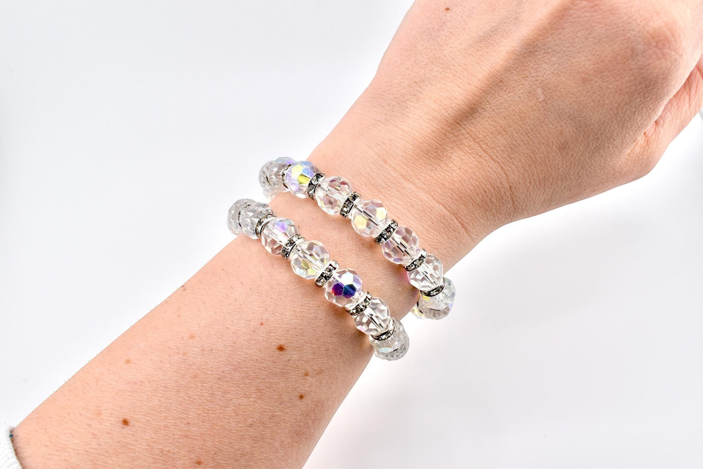 Calathea Collective iridescent crystal wrap bracelet with rhinestone spacer beads on a wrist.