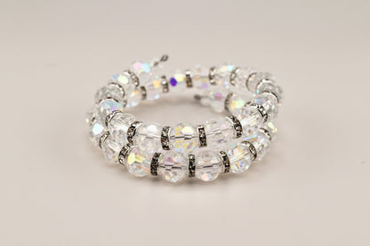 Calathea Collective iridescent crystal wrap bracelet with silver-tone rhinestone spacers. Faceted beads shimmer with pink, blue, and gold hues.