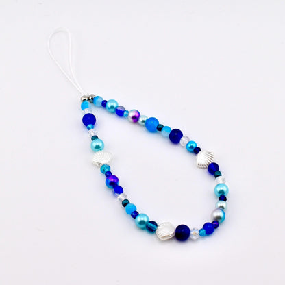 Calathea Collective ocean blue seashell phone charm wrist strap with pearl and glass beads, silver seashell accents.