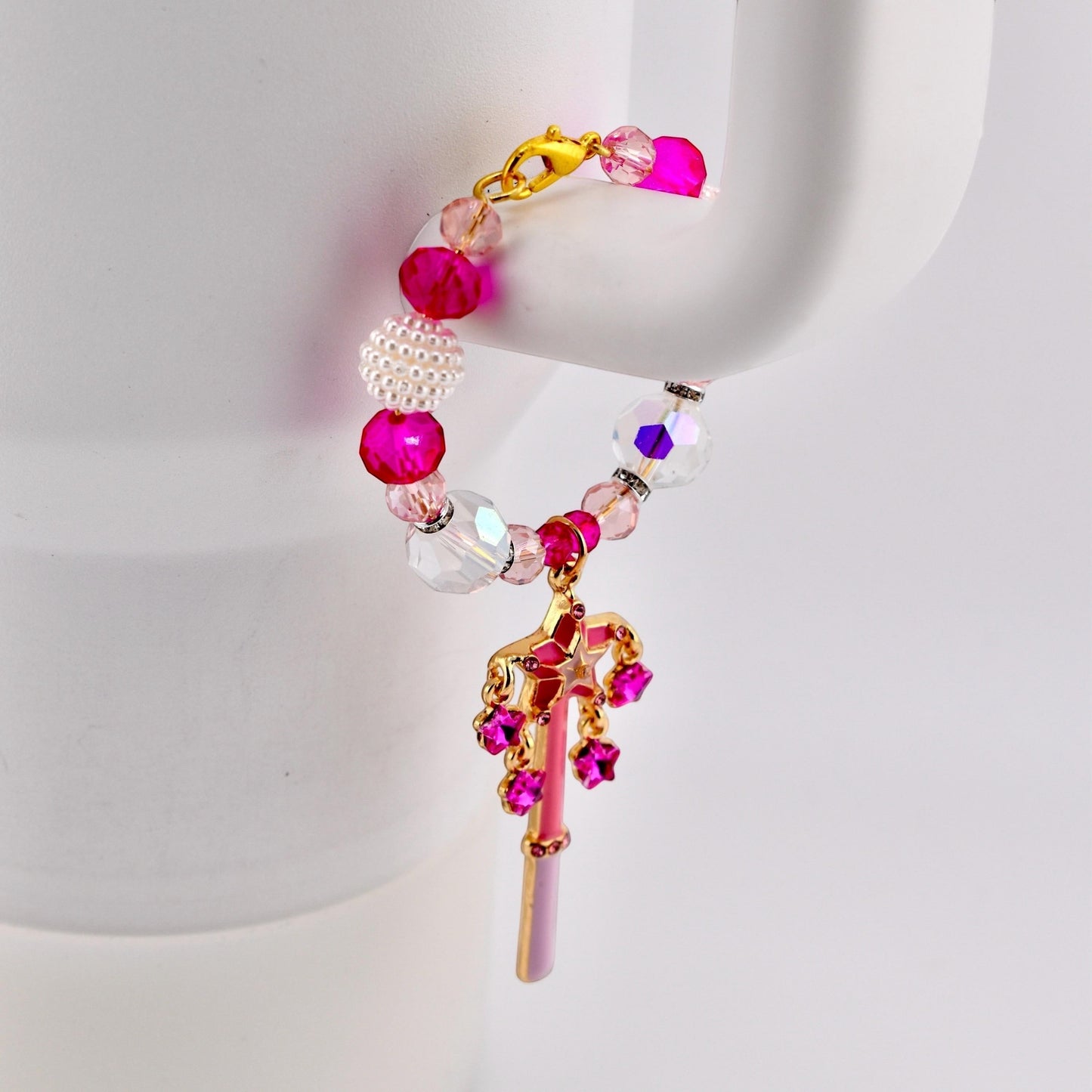 Calathea Collective pink star wand tumbler charm with crystal beads and rhinestone accents on a white tumbler handle.