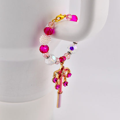 Calathea Collective pink star wand tumbler charm with crystal beads and rhinestone accents on a white tumbler handle.