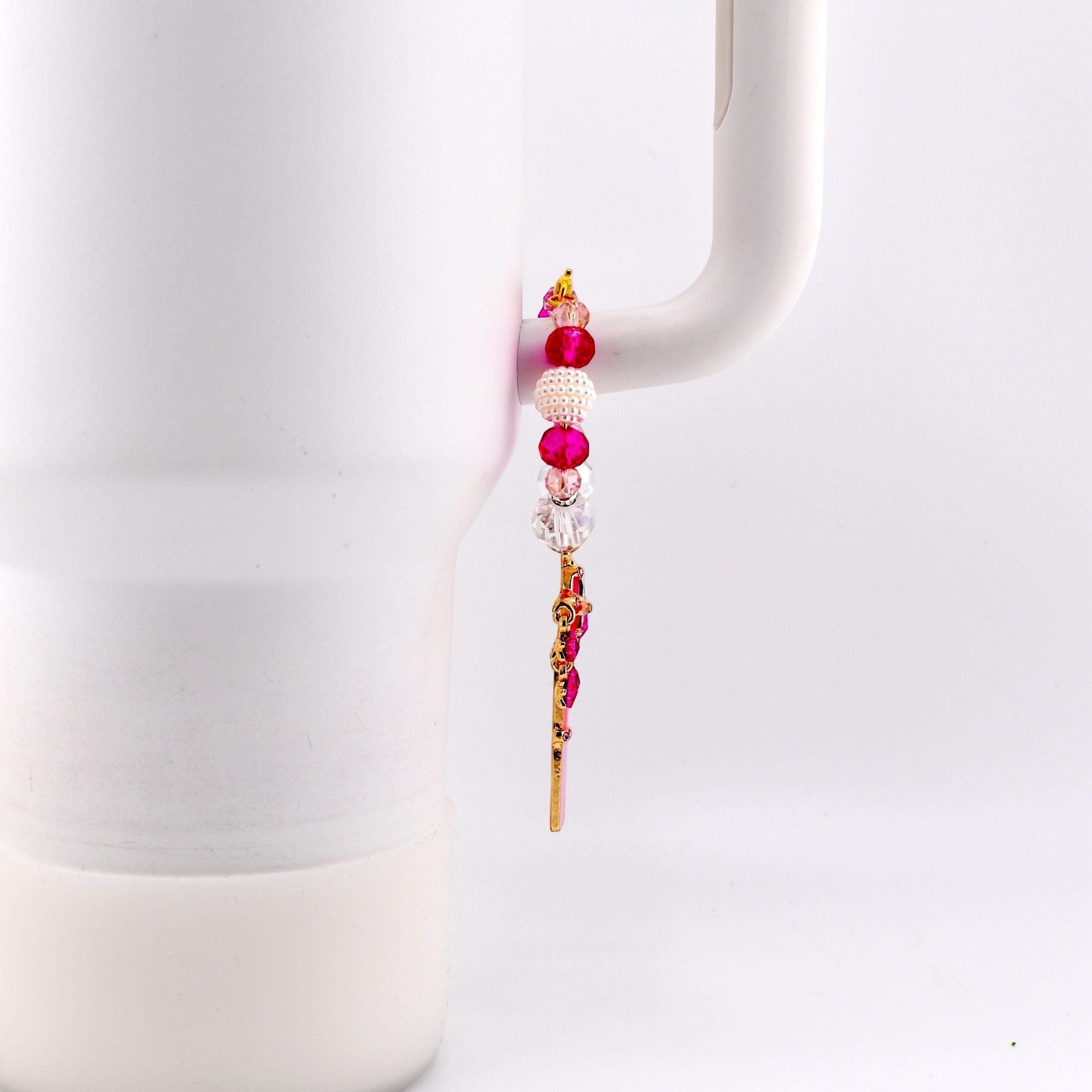 Calathea Collective pink star wand tumbler charm with pink, pearl, and crystal beads on a white tumbler handle.
