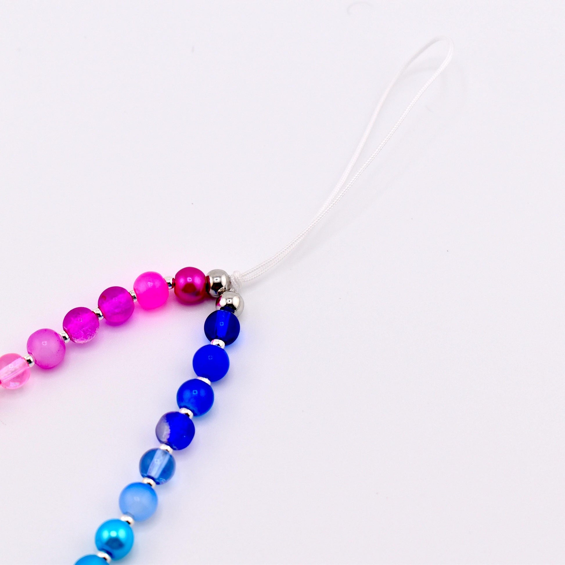 Calathea Collective pastel beaded phone charm wrist strap with pink, purple, blue, and pearl beads and silver spacers.