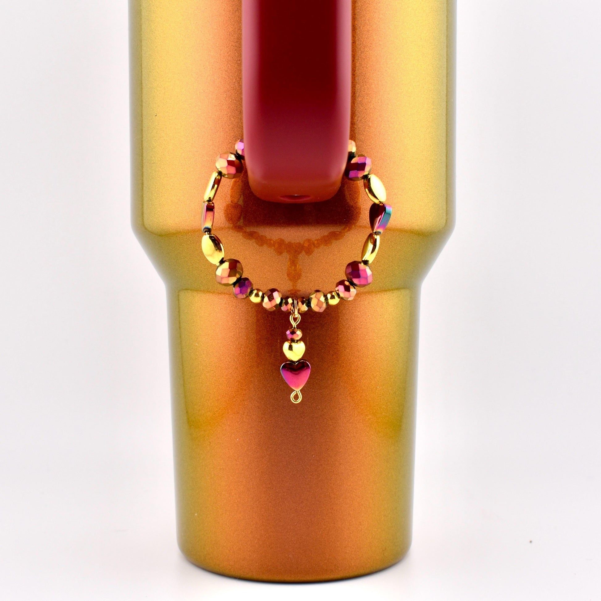 Calathea Collective country gold tumbler handle bracelet with burgundy and gold beads and a heart charm.