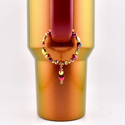 Calathea Collective country gold tumbler handle bracelet with burgundy and gold beads and a heart charm.