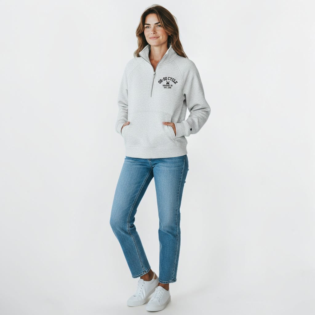 Calathea Collective light gray cropped oversized quarter zip sweatshirt with thumbholes and a front pouch pocket. Features black text logo on chest.