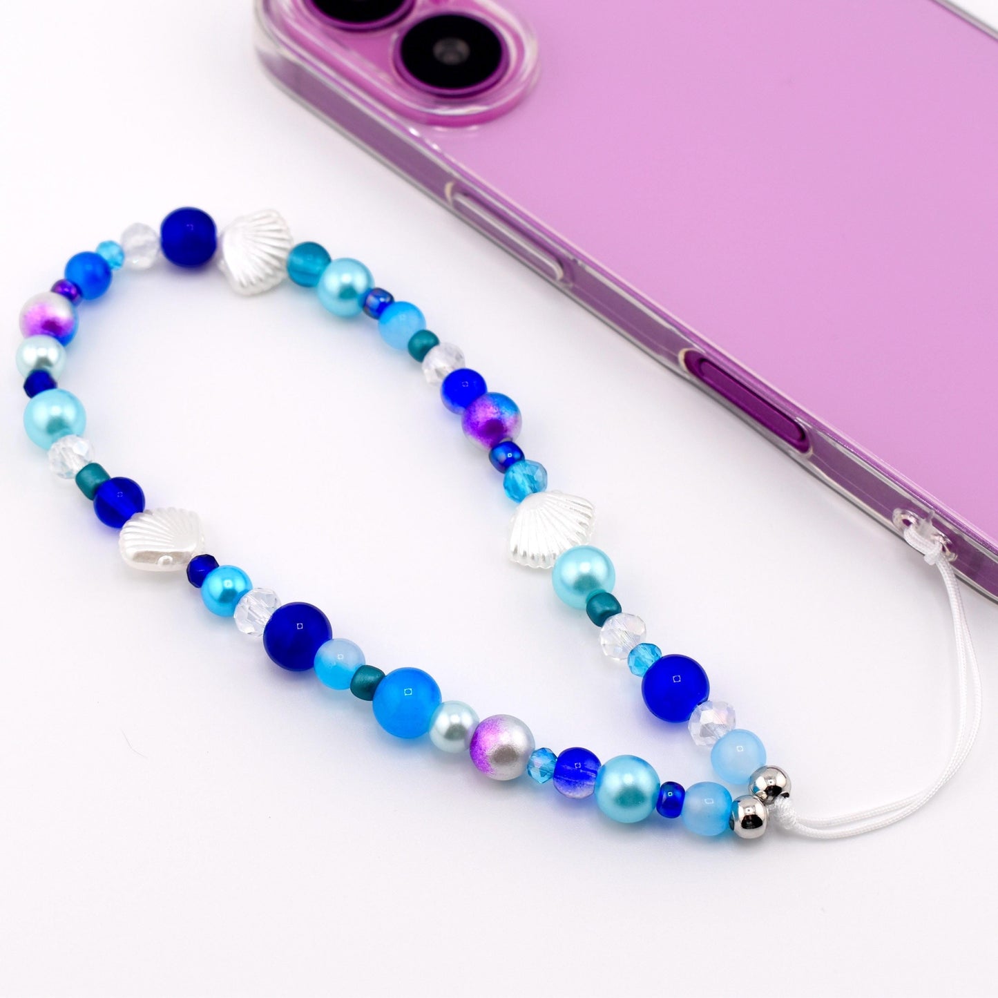 Calathea Collective ocean blue seashell phone charm wrist strap with pearl and glass beads, silver seashell accents.