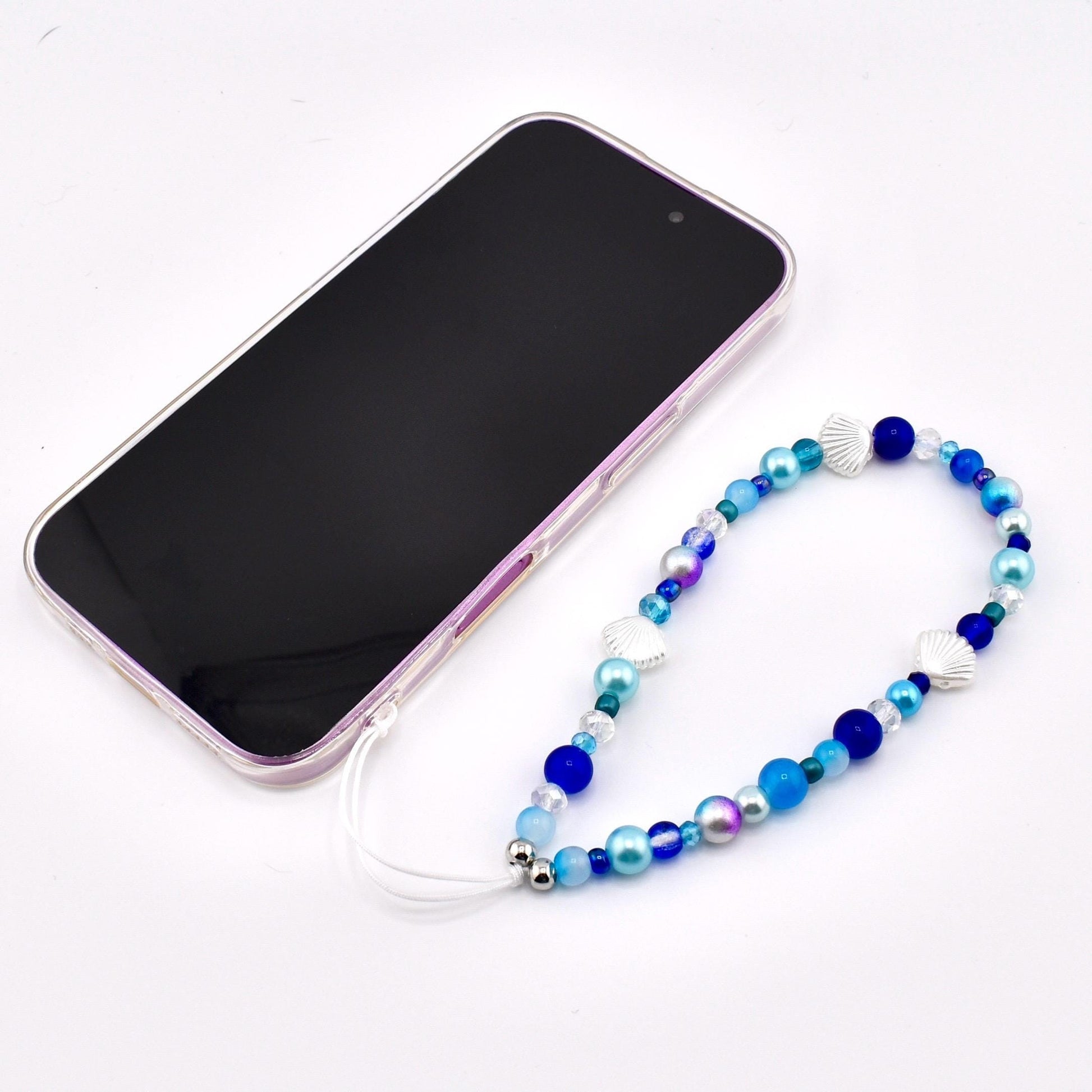 Calathea Collective ocean blue seashell phone charm wrist strap with pearl and glass beads, silver seashell accents.