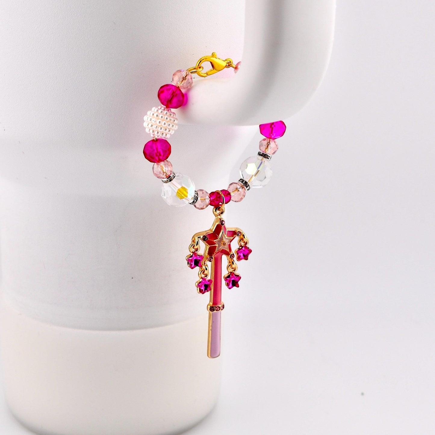 Calathea Collective pink star wand tumbler charm with fuchsia rhinestone stars and crystal beads on a white tumbler handle.