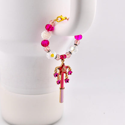 Calathea Collective pink star wand tumbler charm with fuchsia rhinestone stars and crystal beads on a white tumbler handle.