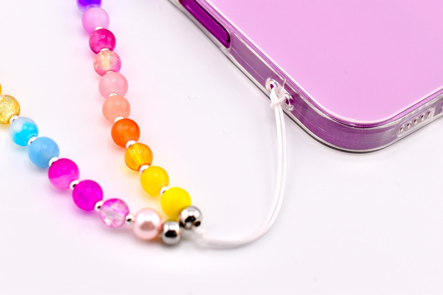 Calathea Collective rainbow beaded phone charm wrist strap with glass beads in pink, magenta, red, orange, yellow, blue, purple, and lavender.
