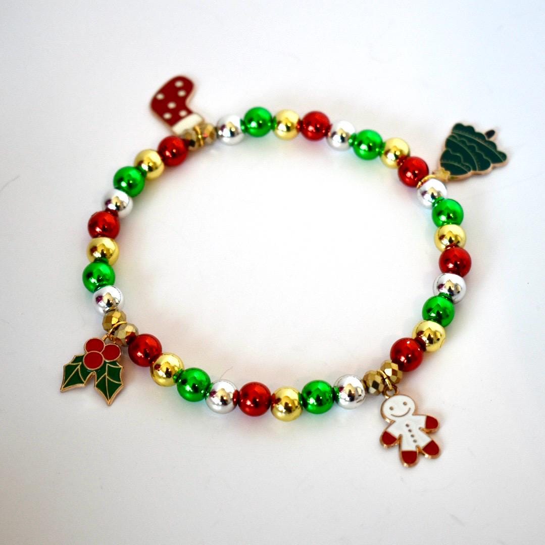 Colorful beaded bracelet with Christmas-themed charms on a white background