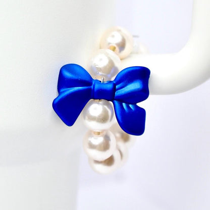Pearl necklace with a blue bow on a white background