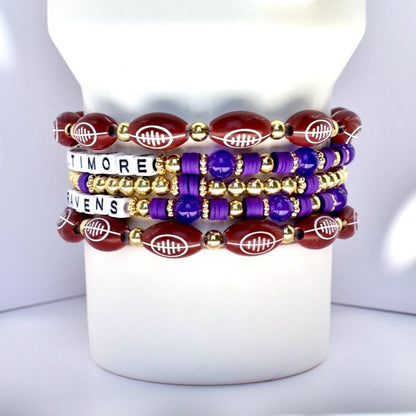 Stack of bracelets with football designs on a white Stanley tumbler