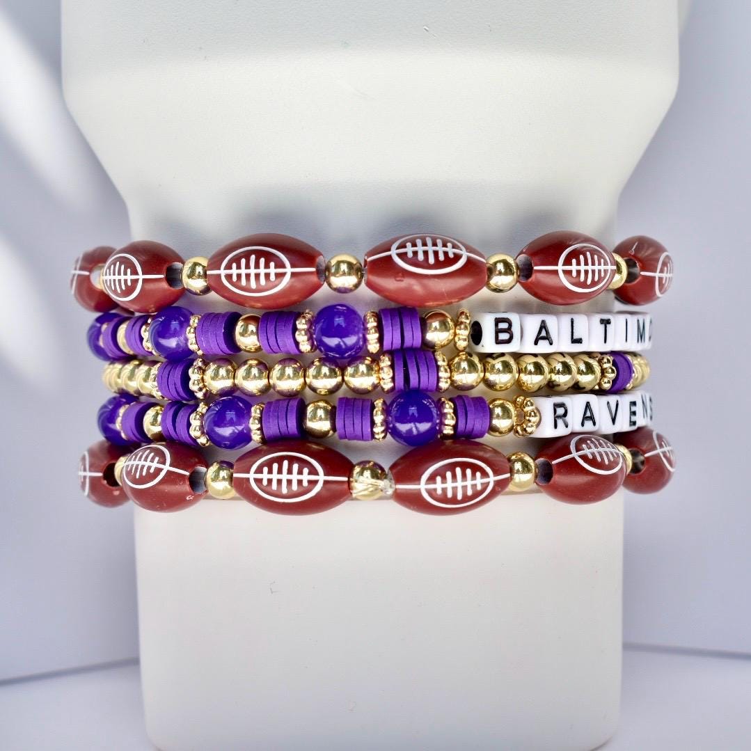 Set of bracelets with football and beaded design on a white Stanley.