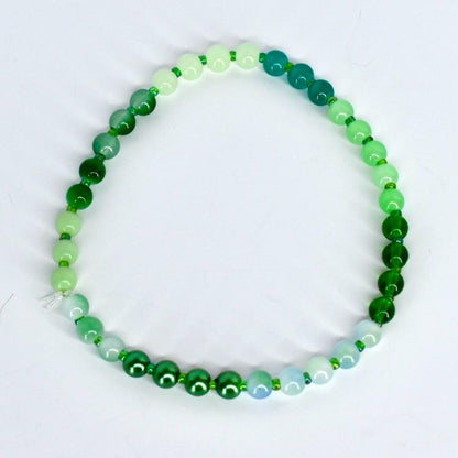 Green beaded bracelet on a white background
