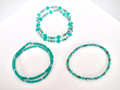 Set of turquoise beaded necklaces on a white background