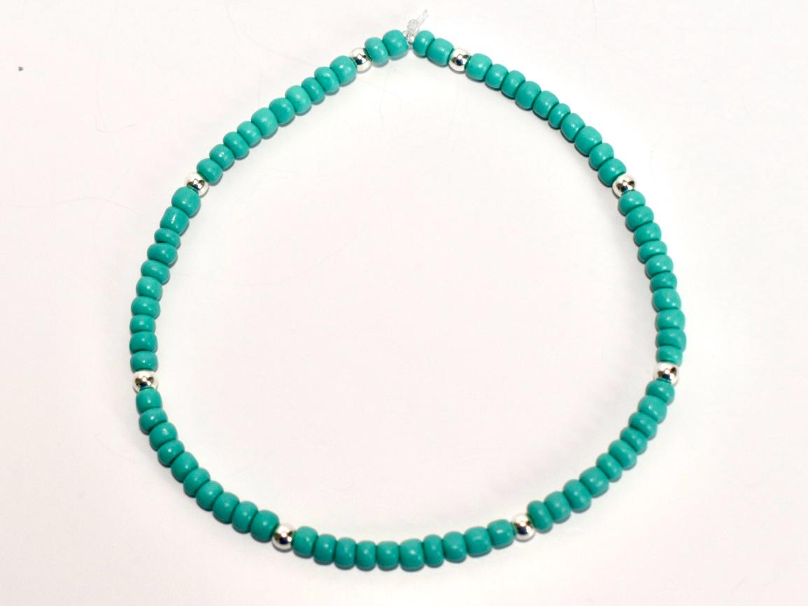 Turquoise beaded necklace on a white background