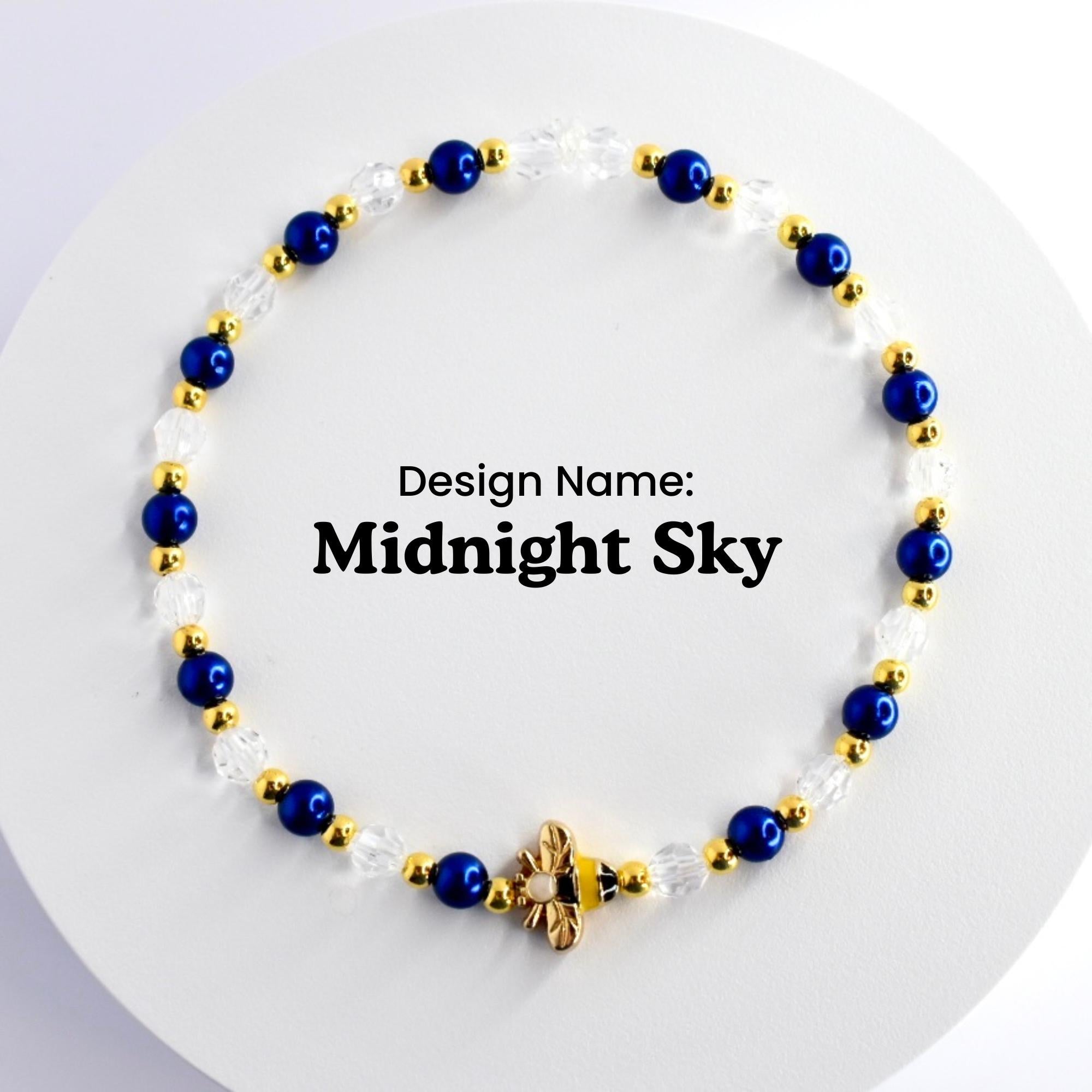 A blue and gold beaded bracelet with a bee charm. The bracelet is made with small blue and clear beads and gold spacers. The text 'Design Name: Midnight Sky' is visible in the center of the image.