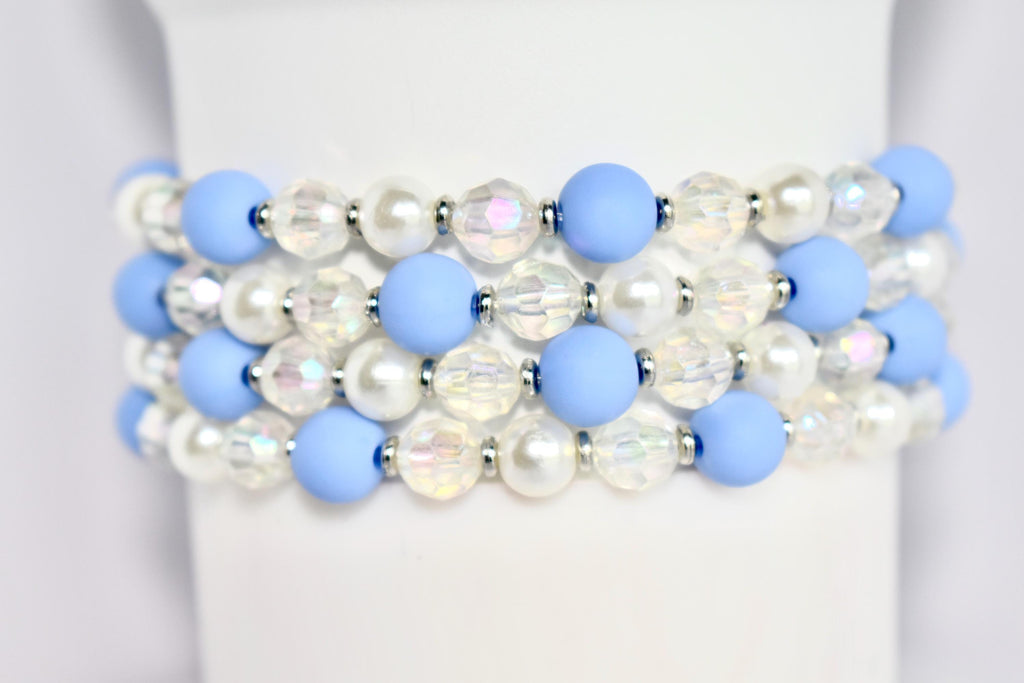 A multi-strand bracelet with light blue, white and iridescent beads.