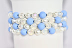 A multi-strand bracelet with light blue, white and iridescent beads.
