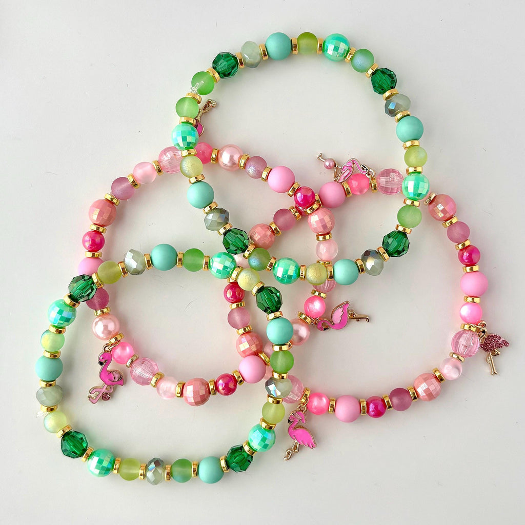 Tropical tumbler bracelet stack with pink and green beads, gold spacers, and flamingo charms, perfect for summer cup jewelry or tropical-themed drinkware decor.