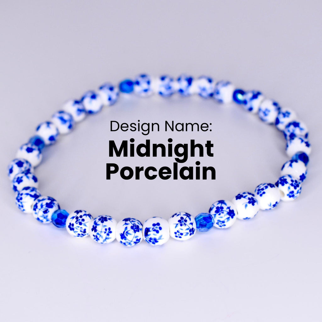 A white bracelet with blue floral designs on each bead. The bracelet has a few dark blue beads interspersed throughout. The text 'Design Name: Midnight Porcelain' is displayed below the bracelet.