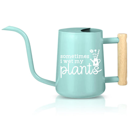 A teal watering can with a wooden handle. The watering can has a spout and a white inscription that reads 'sometimes i wet my plants' with a small flower and watering can graphic.