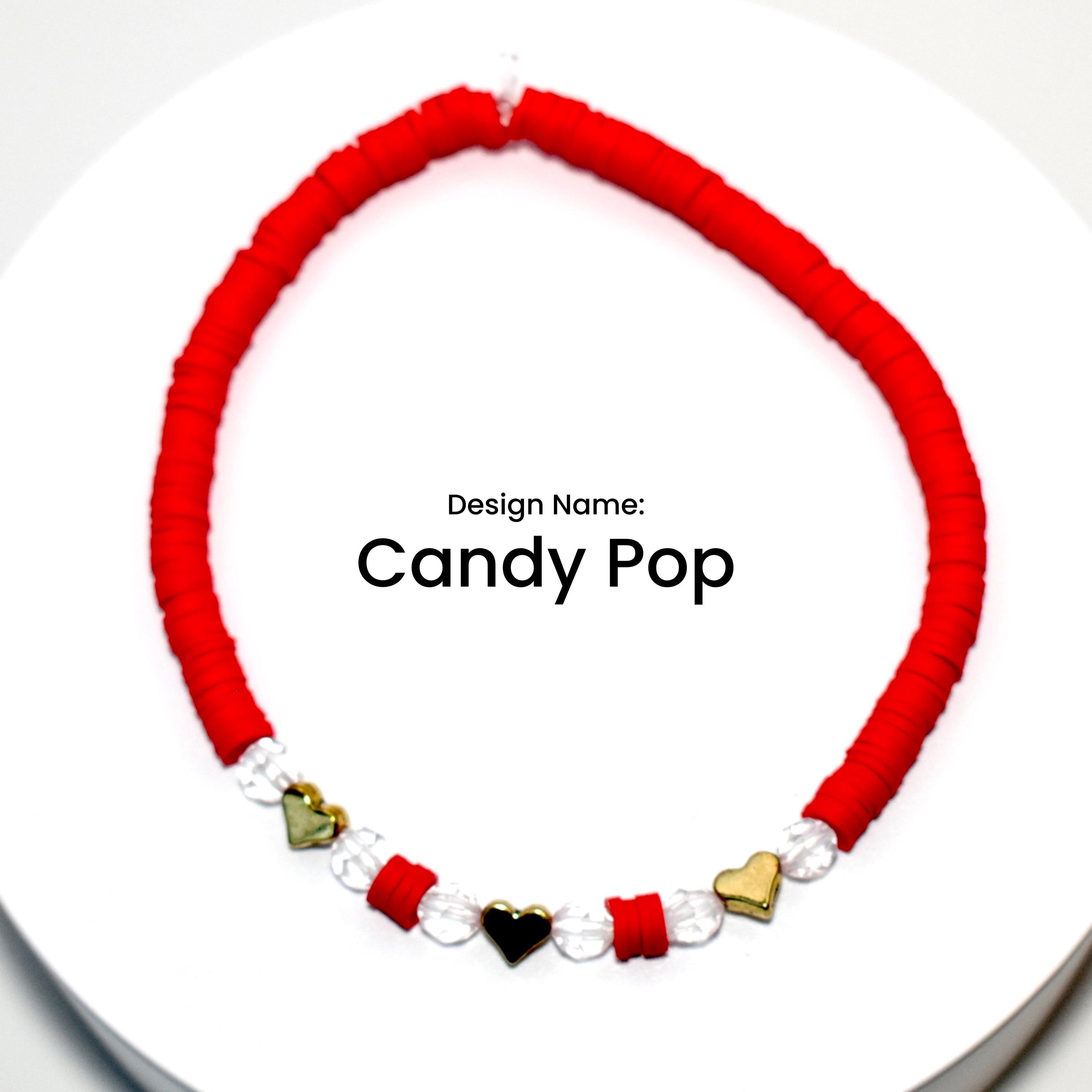 Red and clear beaded bracelet with gold heart charms. Design Name: Candy Pop