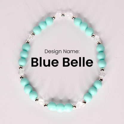 A single bracelet named "Blue Belle" displayed in a circular shape on a light background, made of matte turquoise beads, small silver spacer beads, and clear faceted beads. The design name is centered in bold black text.