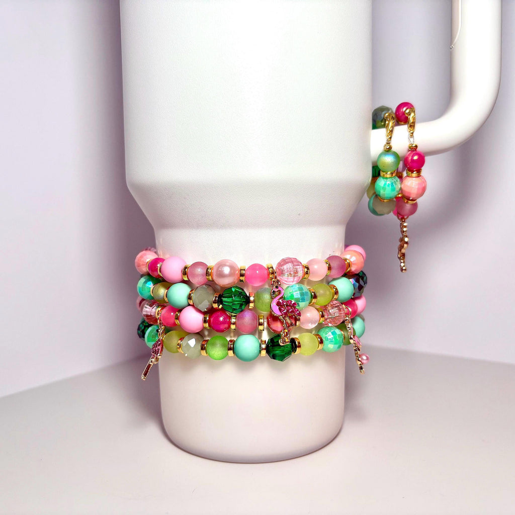 Set of 5 colorful pink and green beaded bracelets wrapped around a white Stanley tumbler, featuring pastel and vibrant glass beads and flamingo charms.