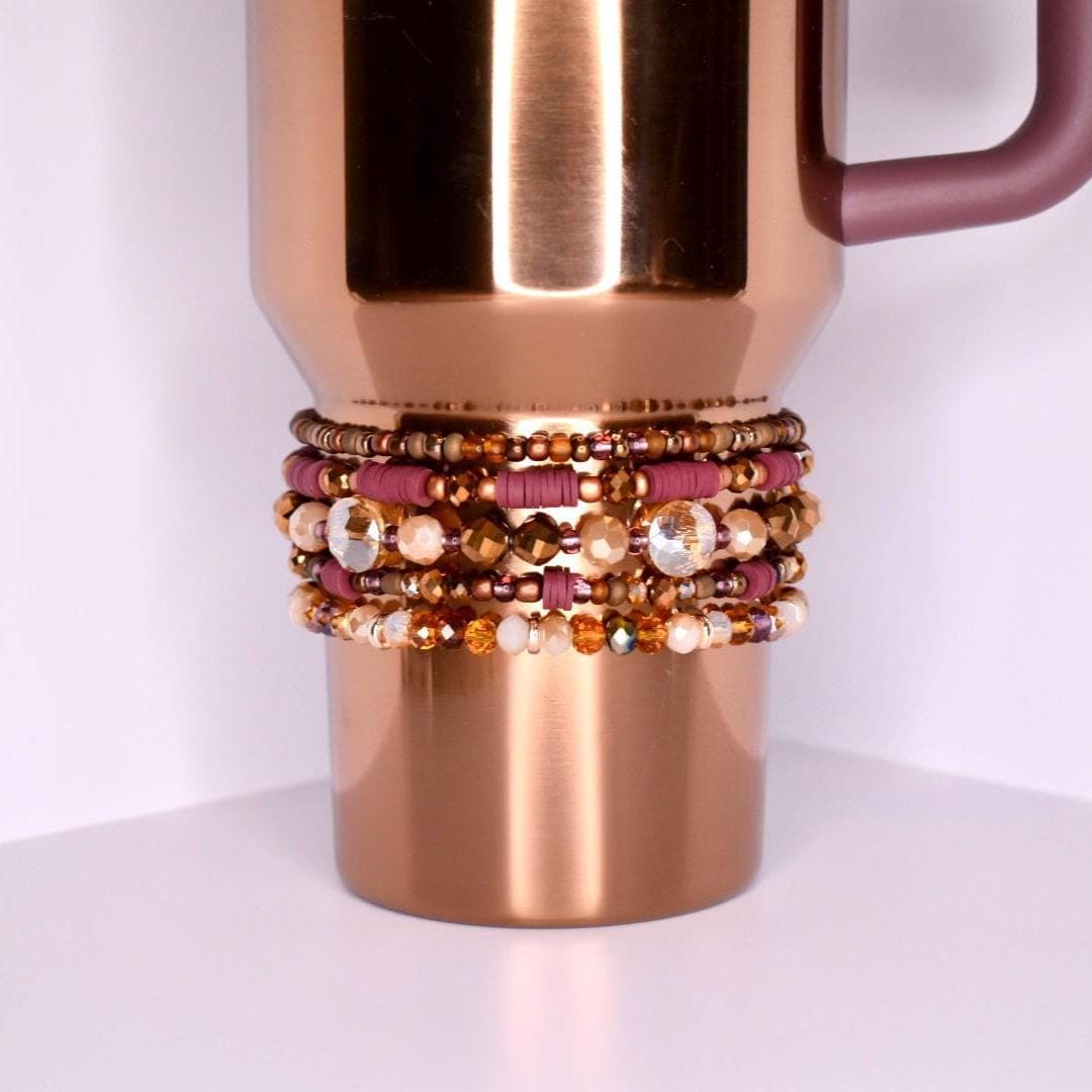 Neutral-toned tumbler bracelets for Stanley-style cups with shimmering rose gold, amber, and mauve beads in a coordinated boho stack of 5